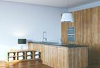 Kuchnia otwarta na salon wykończona drewnem – minimalizm i natura w aranżacji kuchni